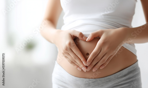 Wallpaper Mural Pregnant woman making heart shape on belly with hands Torontodigital.ca