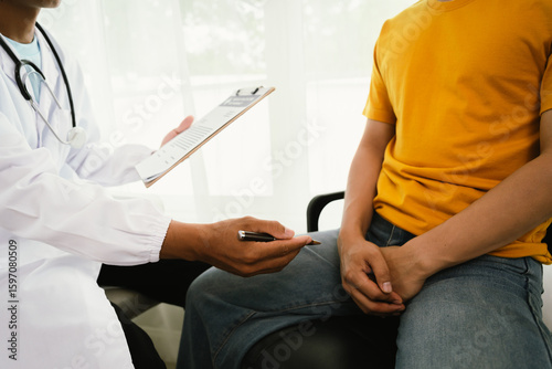 Papier peint A male patient consults a doctor during a medical exam focused on prostate or testicular health, discussing symptoms, diagnosis, and treatment options with trust and professional care