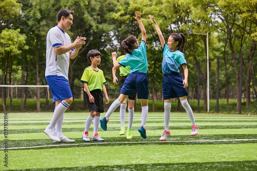 Coach and Kids in Football Training Class