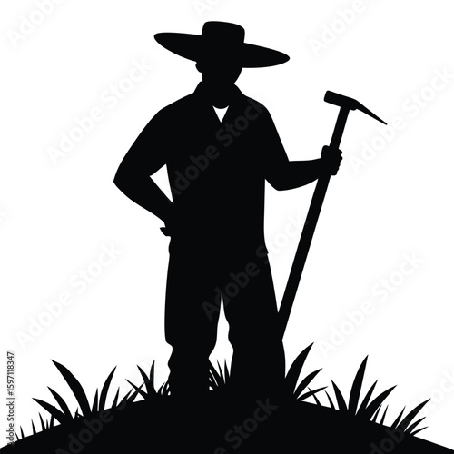 Farmer holding pickaxe standing on grass silhouette