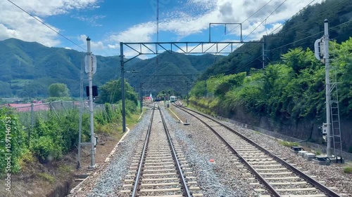 Railway track in the middle of forest in the mountain.  Train railroad in the rural area in South Korea