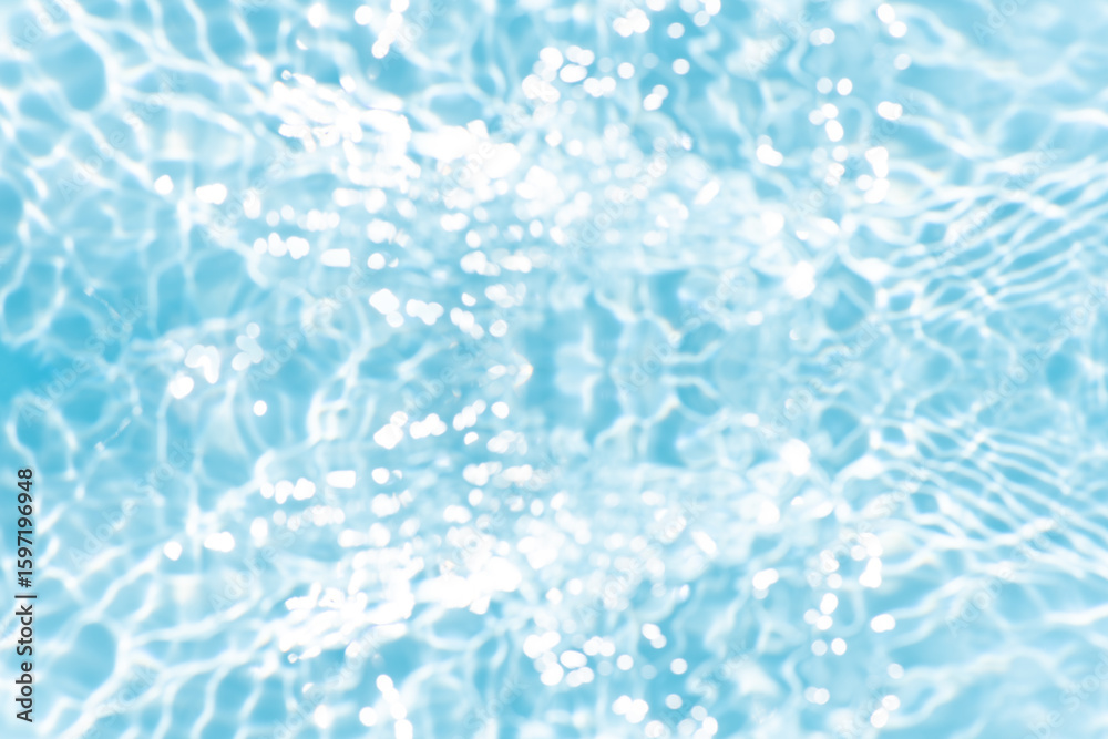 Obraz premium Blue water with ripples on the surface. Defocus blurred transparent blue colored clear calm water surface texture with splashes and bubbles. Water waves with shining pattern texture background.