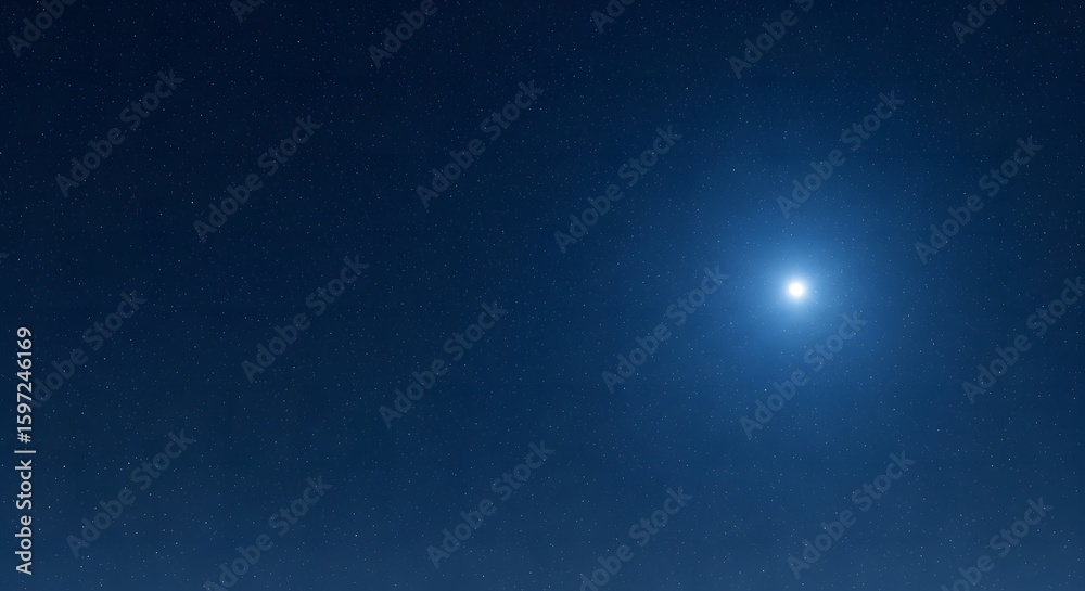 Fototapeta premium Bright blue light source illuminating a dark night sky.