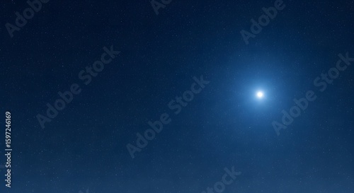 Bright blue light source illuminating a dark night sky.
