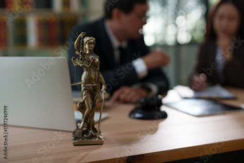 Lawyers are sitting in a meeting, searching for legal documents at the office.	
