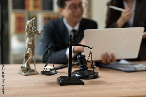 Lawyers and business people discuss legal matters in the office.