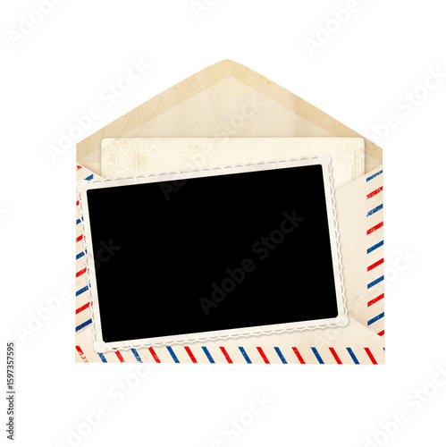 Top view of blank vintage aged opened letter paper envelope with striped edges and photo and card inside. Retro photo frame in old envelope with blank card. Isolated on white background