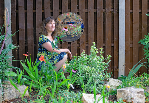 Photography Beautiful woman in a Japanese style landscaped garden.