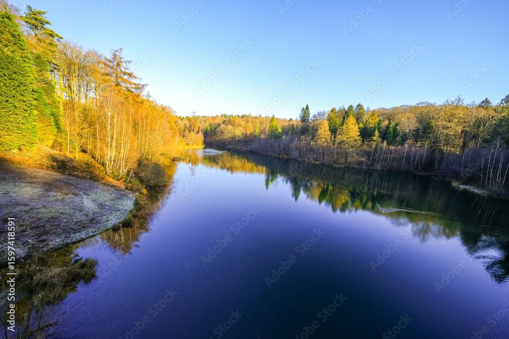 Fototapeta premium View of the Ronsdorf Dam and the surrounding landscape in autumn. Nature at the lake near Wuppertal. Saalbach Dam. 