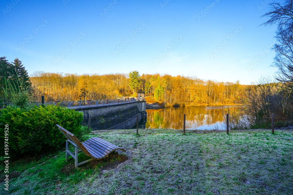 Fototapeta premium View of the Ronsdorf Dam and the surrounding landscape in autumn. Nature at the lake near Wuppertal. Saalbach Dam. 