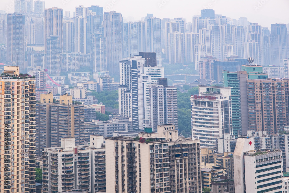 Fototapeta premium View from the rooftop of tall buildings in the Chongqing city, Chongqing is a giant city in southwestern China, founded at the confluence of the Yangtze and Jialingjiang rivers, China