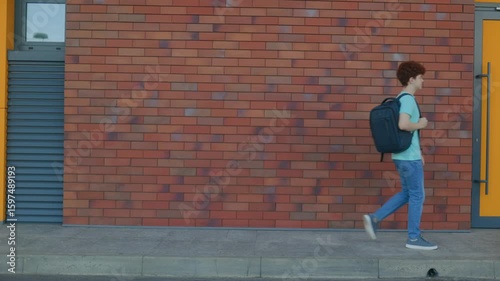 Wallpaper Mural Curly Redhead Teen Boy Walking Calmly in Front of Brick Wall Torontodigital.ca