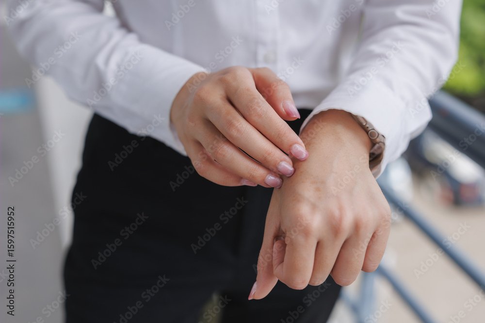 Businesswoman checking pulse on wrist while wearing smartwatch Businesswoman checking pulse on wrist while wearing smartwatch