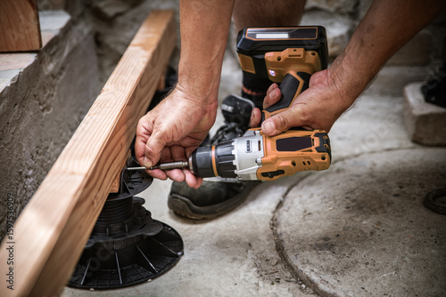 a man builds a terrace floor with douglas fir planks