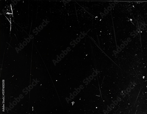 Dark black background texture showing many fine white scratches and numerous small dust particles creating a distressed aged vintage look.