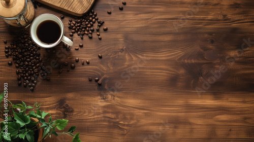 Overhead shot of coffee cup, beans, jar, and greenery on a rustic wooden surface; inviting and warm.