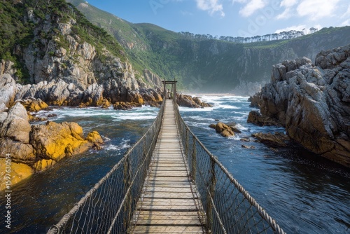 Suspension Bridge at Storm River Mouth in Tsitsikamma National Park, Garden Route South Africa. Scenic Travel Destination with Indian Ocean View