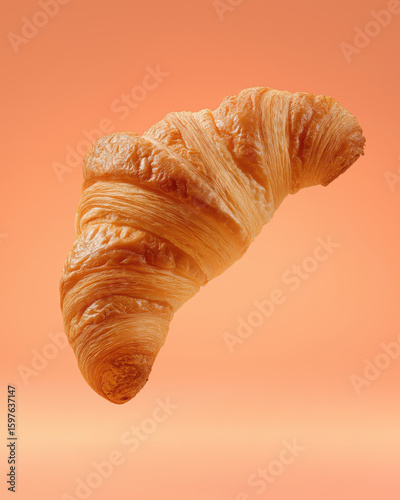 Croissant in Motion – Flaky Golden Layers on Warm Backdrop