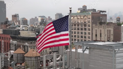 Aerial view of the American flag flying above New York City. Shot on an overcast morning in Manhattan.