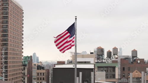 Aerial view of the American flag flying above New York City. Shot on an overcast morning in Manhattan.
