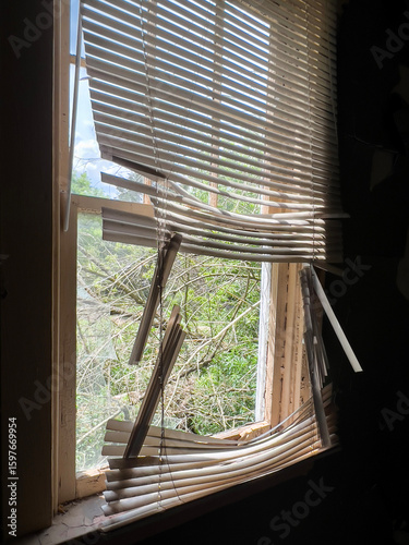 old broken venetian window blinds of an abandoned building