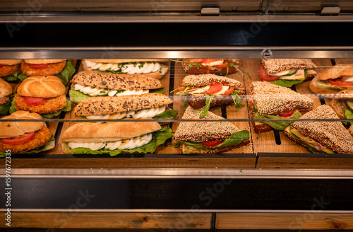 Konstfotografi Fresh assorted sandwiches on display in bakery showcase