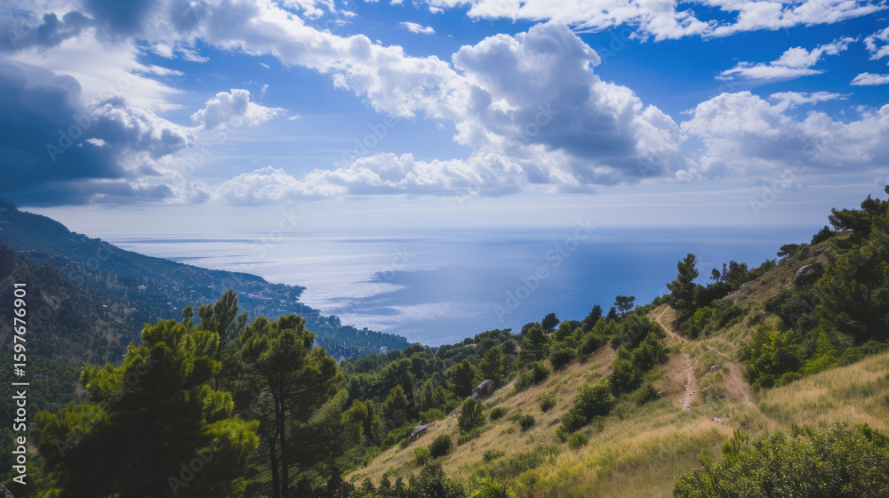 Mountain trail overlooking the ocean under a bright, cloudy sky on a sunny day. Mountain trail overlooking the ocean under a bright, cloudy sky on a sunny day.
