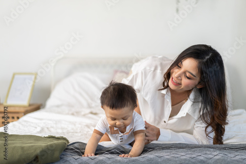 Asian mother play with baby at home, family love and joyful parenting, early childhood development, newborn care, motherhood support, baby insurance, prenatal course and maternal nutrition, mother day