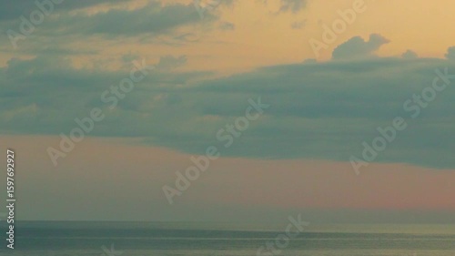 Beautiful Yellow Orange Sunset Sky Cumulus Clouds in Sunlight and Sea, Seashore, Horizon, Colorful Sky Clouds Sun. Background, Ocean Evening Sky Cloud Sun Bay Beach Vacation Travel.