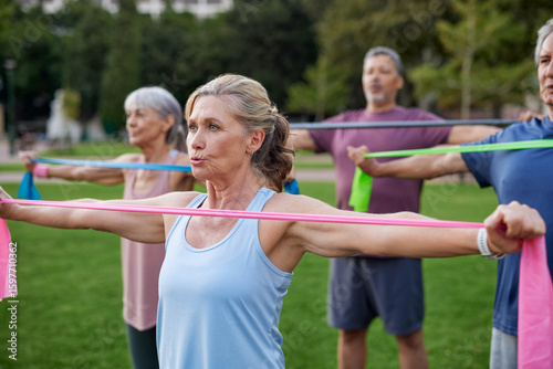 Konstfotografi Mature people exercising with resistance band at park