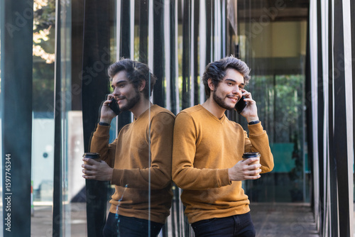 Happy student talking on phone with coffee