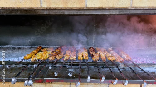 Grilling Delicious Meat on Skewers with Smoke and Charcoal