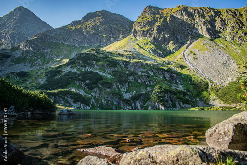 Fototapeta Naklejka Na Ścianę i Meble -  a mountain pond with picturesque views of the mountain peaks