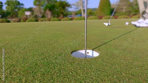 グリーンでパターの練習をするゴルファー