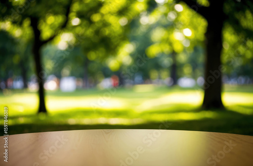 Blurry park scene with tabletop. Green bokeh effect. Nature calm, relaxing.