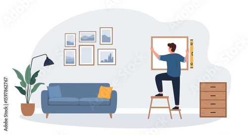 Man Installing A Picture Frame While Standing On A Ladder In The Room