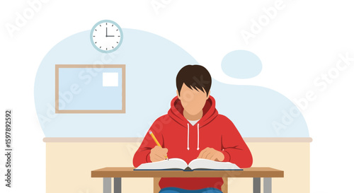 Student Studying At Desk Completing Homework Or Exam Preparation In Class