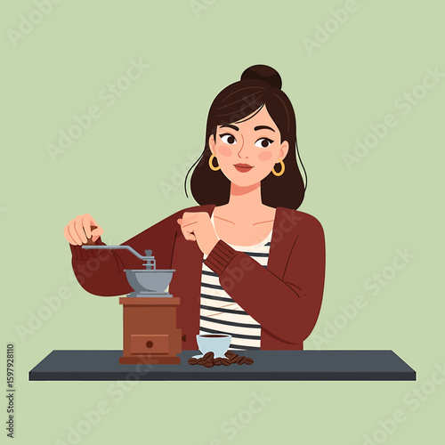 A woman grinds coffee beans using a manual grinder, with a cup and scattered beans on a table.