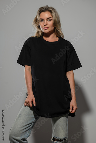 Confident Woman Wearing Oversized Black T-Shirt with Blank Space for Mockup