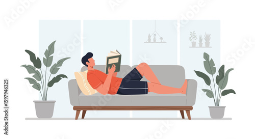 Man Reading A Book Lying On The Sofa Relaxing At Home In Leisure Time