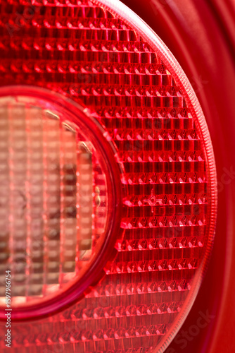 Detail of rear light or  tail-light of famous red Italian supercar. Rosso corsa is the red international motor racing color of cars entered by teams from Italy. Italian national racing color