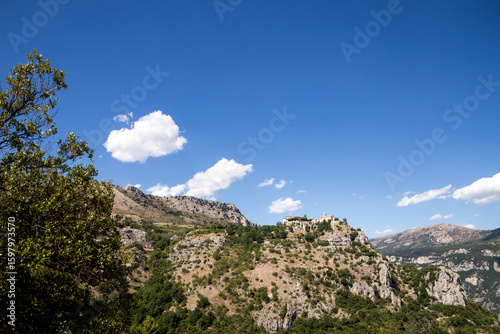 Wide outlook over hills surrounding the French village of Gourdon, among the Most Beautiful Villages of France, a medieval stronghold above the lush Loup Valley within the Alpes-Maritimes department