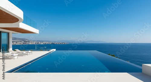 Oceanfront infinity pool and modern architecture on a sunny day for tropical travel