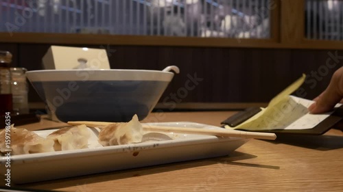 Japanese restaurant Ramen shop table with bill for Pay at the counter system service.