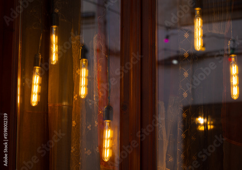 warm light hanging lamps decorative illumination garland windows fuzzy reflection dusk background space