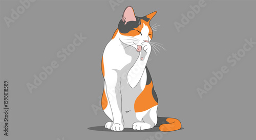 Cute calico cat washing its face with paw adorable feline grooming its fur in a gentle and playful manner