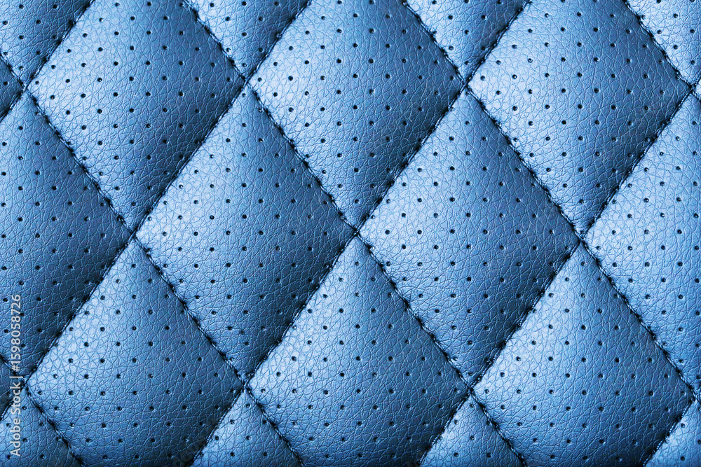 Obraz premium Blue leather texture pattern. Quilted textile material with stitching. Detailed square upholstery background. Soft surface with perforation. Elegant abstract fabric design. Interior decor texture.