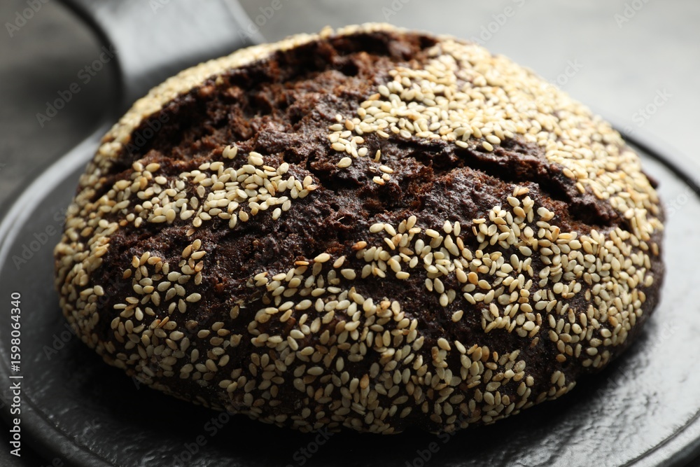 Fototapeta premium Fresh rye bread with seeds on table, closeup