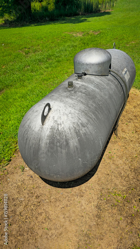 Large industrial propane tank installed outdoors on grass, designed for fuel storage and efficiency. The tank showcases durability and purpose for various industries and homes