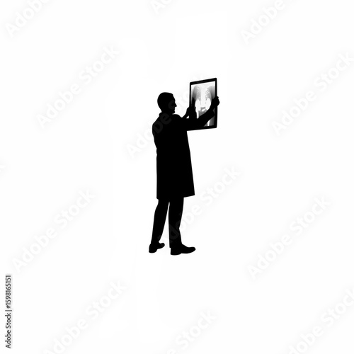 Doctor holding up X-ray to light silhouette on white background